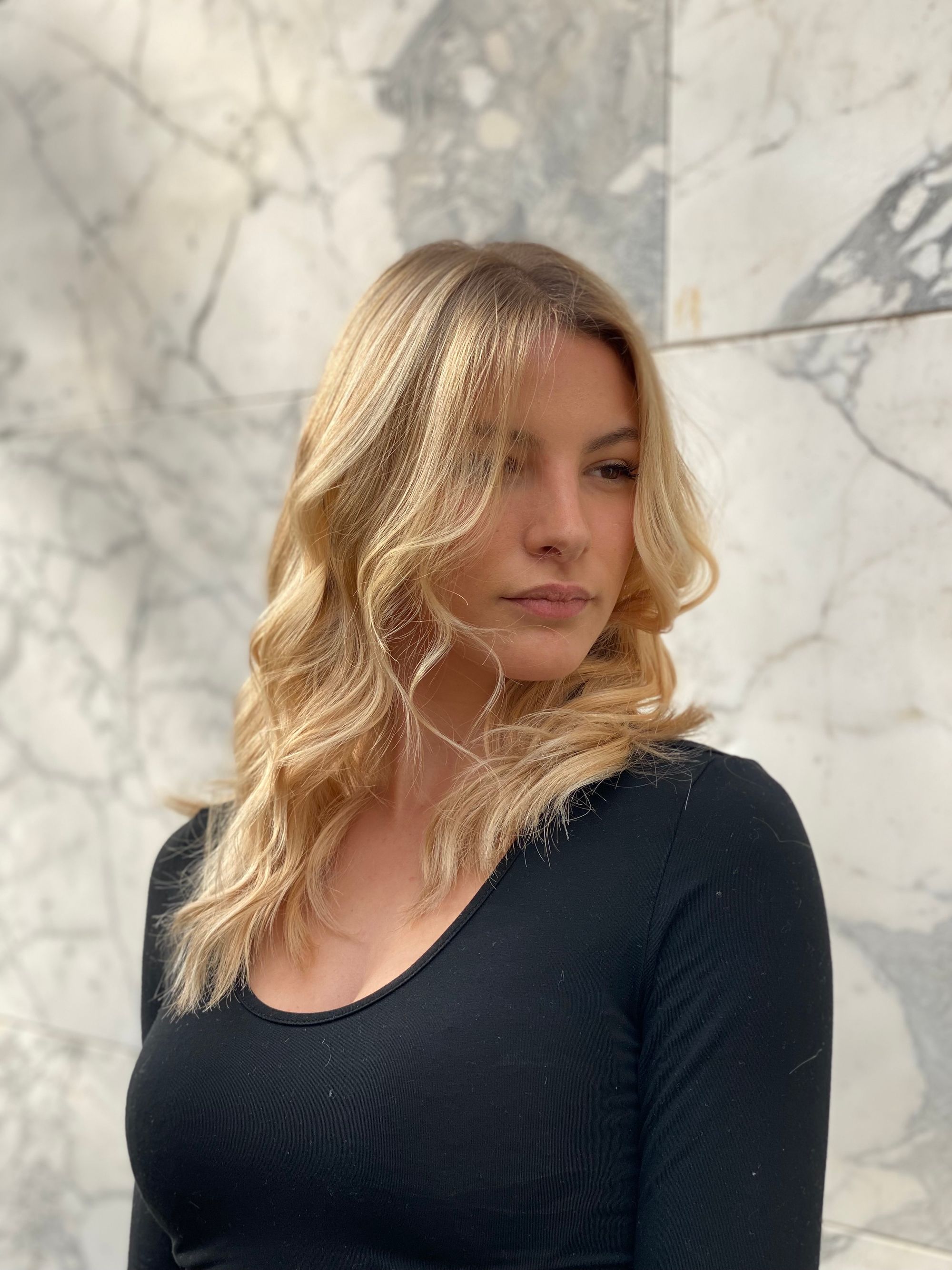Face-framing blonde layers falling past the shoulders